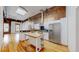 Modern kitchen with stainless steel appliances, butcher block island, and hardwood floors, designed for culinary enthusiasts at 1510 Wazee St # 3, Denver, CO 80202