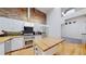 Modern kitchen features stainless steel appliances, an island, and exposed brick accent wall at 1510 Wazee St # 3, Denver, CO 80202
