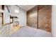Spacious living room features carpet, brick wall, and hardwood floors at 1510 Wazee St # 3, Denver, CO 80202