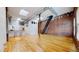 Bright room featuring hardwood floors, a rustic brick wall, and ample space, blending industrial chic with contemporary design at 1510 Wazee St # 3, Denver, CO 80202