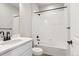 Bathroom featuring a tub/shower combo, white vanity, and dark fixtures, creating a clean and modern space at 1714 Morgan Dr, Erie, CO 80516