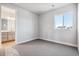 Well-lit bedroom featuring carpet and a window at 1714 Morgan Dr, Erie, CO 80516