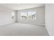 Spacious bedroom with carpet flooring and two windows offering plenty of natural light at 1714 Morgan Dr, Erie, CO 80516
