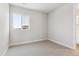 Bedroom with neutral walls, carpeted floor, and a large window, offering ample natural light at 1714 Morgan Dr, Erie, CO 80516