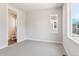 Neutral bedroom with carpet flooring, natural light, and a door leading to the ensuite bathroom at 1714 Morgan Dr, Erie, CO 80516