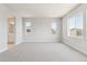Spacious bedroom featuring plush carpet, neutral walls, and plenty of natural light from large windows at 1714 Morgan Dr, Erie, CO 80516
