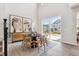 Bright dining room featuring hardwood floors, a dining table, and an oversized window at 1714 Morgan Dr, Erie, CO 80516