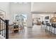 Bright dining room featuring hardwood floors, a dining table, and views into the living room at 1714 Morgan Dr, Erie, CO 80516