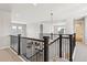 A hallway with dark wood and wrought iron railing overlooking the lower level at 1714 Morgan Dr, Erie, CO 80516