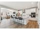 Open kitchen featuring white cabinets, an island with counter seating, and stainless steel appliances at 1714 Morgan Dr, Erie, CO 80516