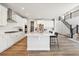 Bright white kitchen featuring an island, modern appliances, and hardwood floors at 1714 Morgan Dr, Erie, CO 80516
