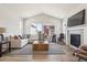 Cozy living room with vaulted ceilings, fireplace, large windows, and comfortable seating at 1714 Morgan Dr, Erie, CO 80516