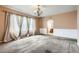 Comfortable bedroom with neutral paint, soft carpet, and access to the bathroom at 2307 S Ensenada St, Aurora, CO 80013