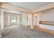 Inviting living room featuring neutral carpet, a bay window, and an open floor plan at 2307 S Ensenada St, Aurora, CO 80013