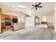 Open living space featuring a kitchen, a carpeted living area, and an entryway at 2307 S Ensenada St, Aurora, CO 80013