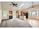 Open living space with a fireplace, a skylight, and an adjacent kitchen area at 2307 S Ensenada St, Aurora, CO 80013