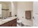 Cozy bathroom featuring a granite vanity countertop, tiled shower, and neutral wall paint at 504 E Dry Creek Pl, Littleton, CO 80122