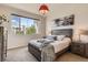 Well-lit bedroom features a large window offering beautiful outdoor views and comfortable furniture at 504 E Dry Creek Pl, Littleton, CO 80122