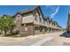 Beautiful townhome complex with brick and siding, attached garages and a well-manicured lawn at 504 E Dry Creek Pl, Littleton, CO 80122