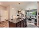 Open-concept kitchen with granite island and stainless appliances, seamlessly flowing into the living and dining areas at 504 E Dry Creek Pl, Littleton, CO 80122