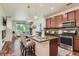 Modern kitchen featuring an island with seating, stainless steel appliances, and an open layout into the living area at 504 E Dry Creek Pl, Littleton, CO 80122