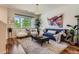 Comfortable living room featuring hardwood floors, modern decor, and large windows offering natural light at 504 E Dry Creek Pl, Littleton, CO 80122