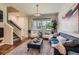 Inviting living room featuring a comfortable sofa, elegant decor, and stairs leading to the upper level at 504 E Dry Creek Pl, Littleton, CO 80122