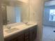 Bathroom featuring double sinks, a large mirror, and modern fixtures at 17117 W 91St Ln, Arvada, CO 80007