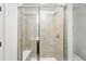 Modern bathroom features glass shower with seat and ceramic tile walls at 17117 W 91St Ln, Arvada, CO 80007