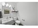 Elegant half bathroom with modern fixtures, floating shelves and decorative details at 17117 W 91St Ln, Arvada, CO 80007