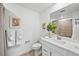 Bright bathroom featuring modern fixtures, a vanity with sink, and decorative accents at 17117 W 91St Ln, Arvada, CO 80007
