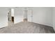 Spacious bedroom featuring neutral carpet, white walls, and two entry doors at 17117 W 91St Ln, Arvada, CO 80007
