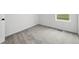 Empty bedroom showcasing neutral carpet and a single window at 17117 W 91St Ln, Arvada, CO 80007