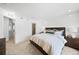 Bedroom includes views to the bathroom, hallway, walk-in closet and modern decor at 17117 W 91St Ln, Arvada, CO 80007