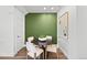 Bright dining area featuring a round table with seating for four, modern decor, and wood-look flooring at 17117 W 91St Ln, Arvada, CO 80007