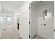 Bright hallway with plush neutral carpeting and white doors, offering a glimpse into the home's interior at 17117 W 91St Ln, Arvada, CO 80007