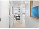 Hallway leads to a room with a desk, chair, and shelves near a window, perfect for a home office at 17117 W 91St Ln, Arvada, CO 80007