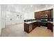 Modern kitchen features stainless appliances, wooden cabinets, and beautiful tile backsplash at 17117 W 91St Ln, Arvada, CO 80007