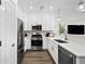 Bright kitchen features stainless steel appliances, white cabinets, and modern countertops at 17117 W 91St Ln, Arvada, CO 80007