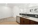 Open-concept kitchen with stainless steel appliances, black backsplash, and a breakfast bar at 17117 W 91St Ln, Arvada, CO 80007