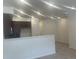 Open concept kitchen features stainless appliances, eat-in bar, and abundant lighting at 17117 W 91St Ln, Arvada, CO 80007