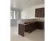 An in-progress kitchen boasts brown cabinets and an island, awaiting final touches in a bright, airy space at 17117 W 91St Ln, Arvada, CO 80007