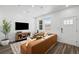 Inviting living room featuring modern furniture, a media console, and natural light at 17117 W 91St Ln, Arvada, CO 80007