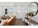Bright living room with a large window, modern decor, and wood-look flooring at 17117 W 91St Ln, Arvada, CO 80007