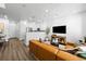 Open concept living space with modern furnishings, stylish decor, and wood-look flooring at 17117 W 91St Ln, Arvada, CO 80007