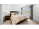 Bedroom featuring large window with scenic views, decorative headboard and modern decor at 17117 W 91St Ln, Arvada, CO 80007