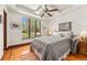 Bright bedroom with ceiling fan, hardwood floors, and large window with outdoor view at 740 Carr St, Lakewood, CO 80214
