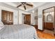 Cozy bedroom with a ceiling fan, hardwood floors, and access to the bathroom at 740 Carr St, Lakewood, CO 80214