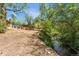 Creek running alongside backyard, house in background, with trees and grass at 740 Carr St, Lakewood, CO 80214
