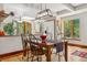 Inviting dining area featuring a wooden table, bright windows, and an adjacent kitchen space at 740 Carr St, Lakewood, CO 80214